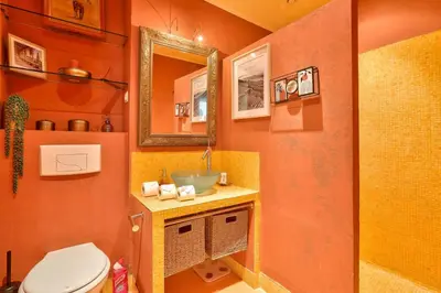 a bathroom with a toilet and a sink at L'Écrin d'Azur – Villa, Cinéma & Plage à 50m in Cannes