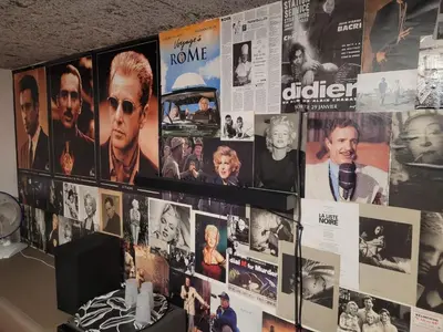 a wall full of movie posters and magazines at L'Écrin d'Azur – Villa, Cinéma & Plage à 50m in Cannes