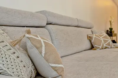 a gray couch with pillows on top of it at Moderne et Chic T3, à deux pas de la Croisette in Cannes