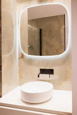 a bathroom with a white sink and a mirror at Moderne et Chic T3, à deux pas de la Croisette in Cannes