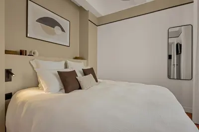 a bedroom with a large white bed with pillows at Exceptionnel face Palais Cannes in Cannes