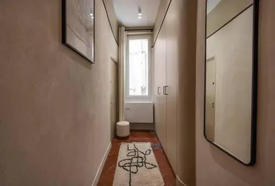 a hallway with a window and a door with a rug at Exceptionnel face Palais Cannes in Cannes