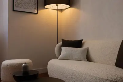 a living room with a couch and a lamp at Exceptionnel face Palais Cannes in Cannes