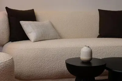 a white couch with pillows and a vase on a table at Exceptionnel face Palais Cannes in Cannes