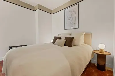 a white bedroom with a white bed and a table at Exceptionnel face Palais Cannes in Cannes