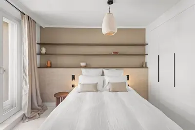 a bedroom with a white bed with two pillows at Extraordinaire avec terrasse in Cannes