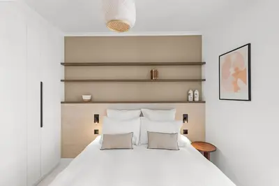 a bedroom with a large white bed with two pillows at Extraordinaire avec terrasse in Cannes