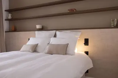 a large white bed with pillows on top of it at Extraordinaire avec terrasse in Cannes