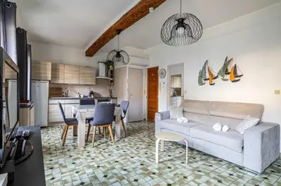 a living room with a couch and a table at LE FORVILLE lumineux en plein centre, à deux pas du Palais, Croisette et plages in Cannes