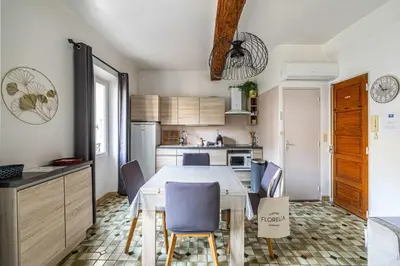 a kitchen and dining room with a table and chairs at LE FORVILLE lumineux en plein centre, à deux pas du Palais, Croisette et plages in Cannes