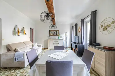a living room with a table and a couch at LE FORVILLE lumineux en plein centre, à deux pas du Palais, Croisette et plages in Cannes