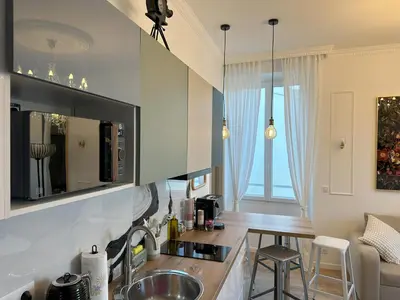 a kitchen with a sink and a counter top at Le cœur de Cannes in Cannes