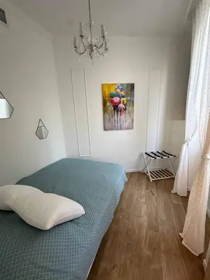 a bedroom with a bed and a painting on the wall at Le cœur de Cannes in Cannes