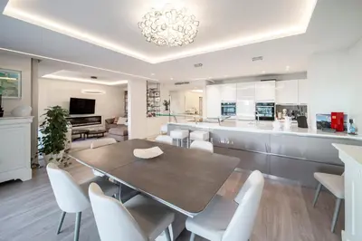 a kitchen and dining room with a table and chairs at REF 1924 - Cannes Croisette - Sea view apartment for rent in Cannes