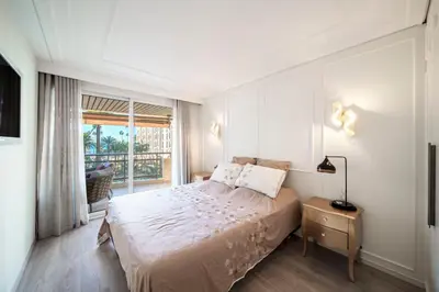 a bedroom with a large bed and a window at REF 1924 - Cannes Croisette - Sea view apartment for rent in Cannes