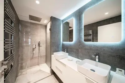 a bathroom with a white sink and a mirror at REF 1924 - Cannes Croisette - Sea view apartment for rent in Cannes