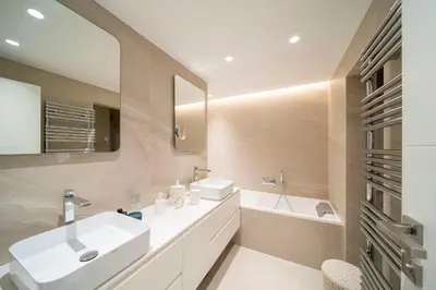 a bathroom with a sink and a mirror and a tub at REF 1924 - Cannes Croisette - Sea view apartment for rent in Cannes