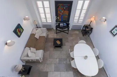 an overhead view of a living room with a couch at Maison Julia- Triplex avec rooftop terrasse vue sur mer et cathédrale, 10 mins à pieds du palais et plages in Cannes