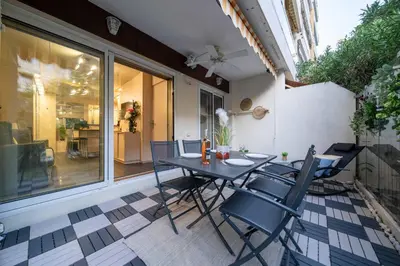 a patio with a table and chairs on a balcony at Ciel d Azur avec terrasse en plein centre près de la Croisette in Cannes