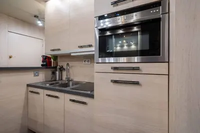 a kitchen with a sink and a microwave at Ciel d Azur avec terrasse en plein centre près de la Croisette in Cannes