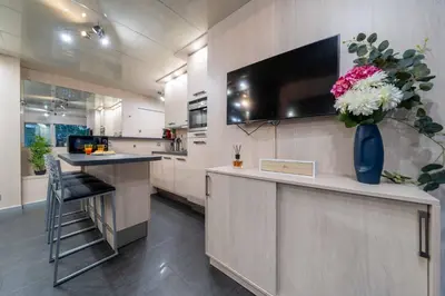 a kitchen with a counter with a vase of flowers at Ciel d Azur avec terrasse en plein centre près de la Croisette in Cannes