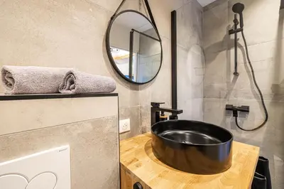 a bathroom with a black sink and a mirror at 5 CARNOT - Beautiful apartment, 4 people, 150m from Palais des Festivals in Cannes