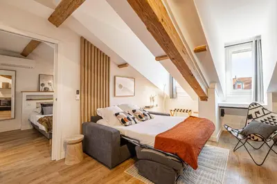 a bedroom with a bed and a chair in a room at 5 CARNOT - Beautiful apartment, 4 people, 150m from Palais des Festivals in Cannes