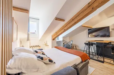 a bedroom with a bed and a desk in it at 5 CARNOT - Beautiful apartment, 4 people, 150m from Palais des Festivals in Cannes