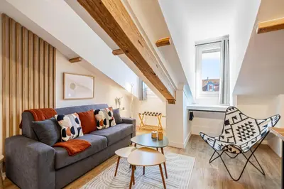 a living room with a couch and a table at 5 CARNOT - Beautiful apartment, 4 people, 150m from Palais des Festivals in Cannes