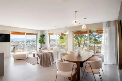 a living room with white furniture and a table and chairs at REF 1965 - Le Cannet - Sea view apartment for rent in Le Cannet