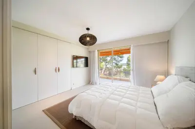 a white bedroom with a large bed and a window at REF 1965 - Le Cannet - Sea view apartment for rent in Le Cannet