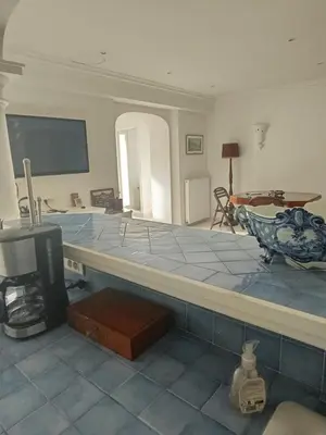 a living room with a tv and a table at La matoune in Cannes