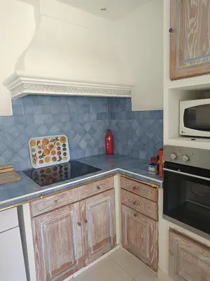 a kitchen with a blue tiled counter top at La matoune in Cannes