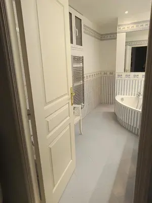 an open door to a bathroom with a tub and a sink at La matoune in Cannes