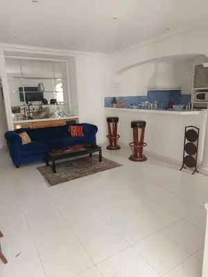 a living room with a blue couch and a table at La matoune in Cannes