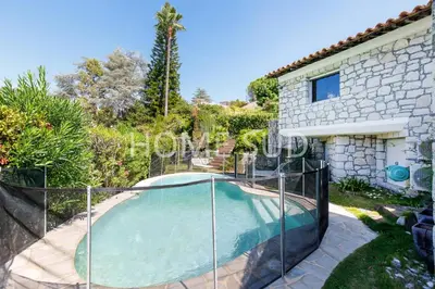 a villa with a swimming pool and a house at Votre maison de vacances dans un écrin de verdure - Cannes in Cannes