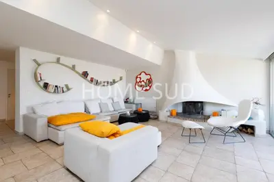 a living room with white furniture and a fireplace at Votre maison de vacances dans un écrin de verdure - Cannes in Cannes
