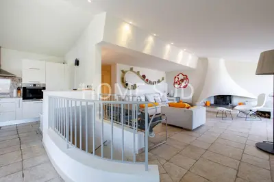 a kitchen and living room with a staircase in a house at Votre maison de vacances dans un écrin de verdure - Cannes in Cannes