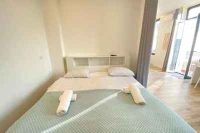 a bedroom with a bed with two towels on it at 06CJ Beautiful apartment in the heart of Cannes in Cannes