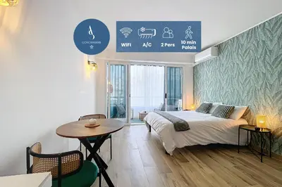 a bedroom with a bed and a table in it at L'Hippocampe - Studio - Croisette - Proche Palais in Cannes
