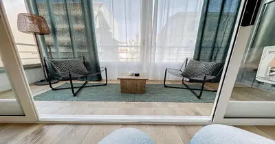 a room with two chairs and a table and a lamp at L'Hippocampe - Studio - Croisette - Proche Palais in Cannes