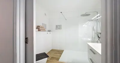 a white bathroom with a shower and a toilet at L'Hippocampe - Studio - Croisette - Proche Palais in Cannes