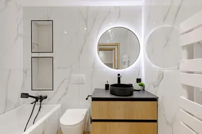 a bathroom with a sink and a toilet and a mirror at Cannes apartment sea view - 18H in Cannes