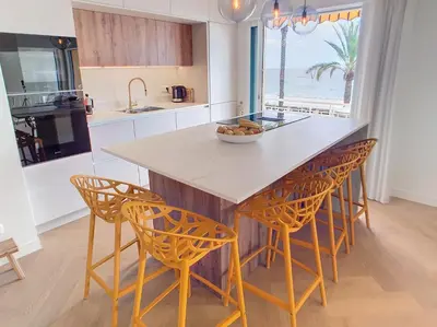 a kitchen with a table and chairs with a view of the ocean at Une véritable perle 342L HUI in Cannes