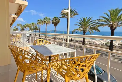 a table and chairs on a balcony overlooking the ocean at Une véritable perle 342L HUI in Cannes