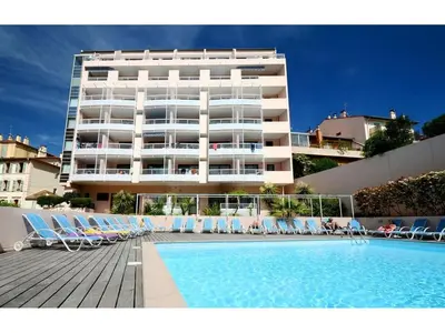 a large building with chairs and a swimming pool at A deux pas des plages du Midi 308L Mour in Cannes