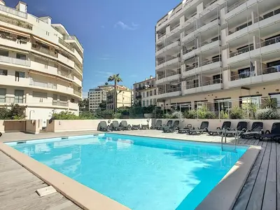 a large swimming pool in front of a building at A deux pas des plages du Midi 308L Mour in Cannes