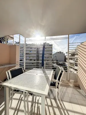 a white table and chairs on a balcony at A deux pas des plages du Midi 308L Mour in Cannes