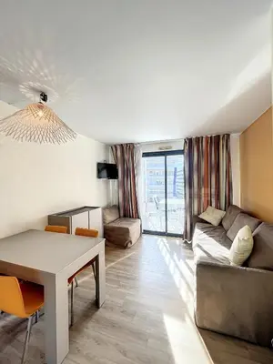a living room with a table and a couch at A deux pas des plages du Midi 308L Mour in Cannes
