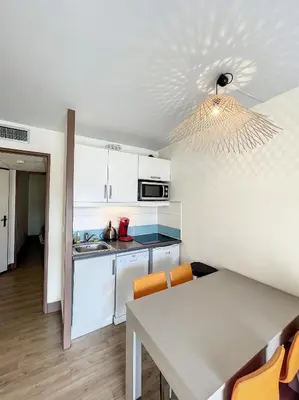 a kitchen and dining room with a table and chairs at A deux pas des plages du Midi 308L Mour in Cannes